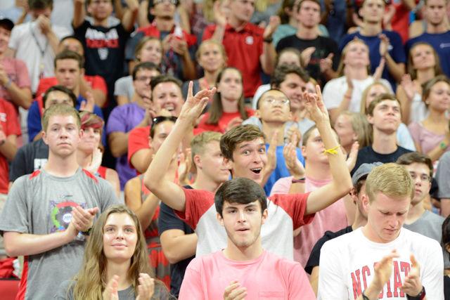 Brandon Guiterrez, a freshman studying computer engineering, throws up a wolfie while being taught classic NC State cheers at Convocation in PNC Arena on Aug. 15, 2016. The class of 2020 learned the words to the alma mater, red and white song, and many other NC State classics.