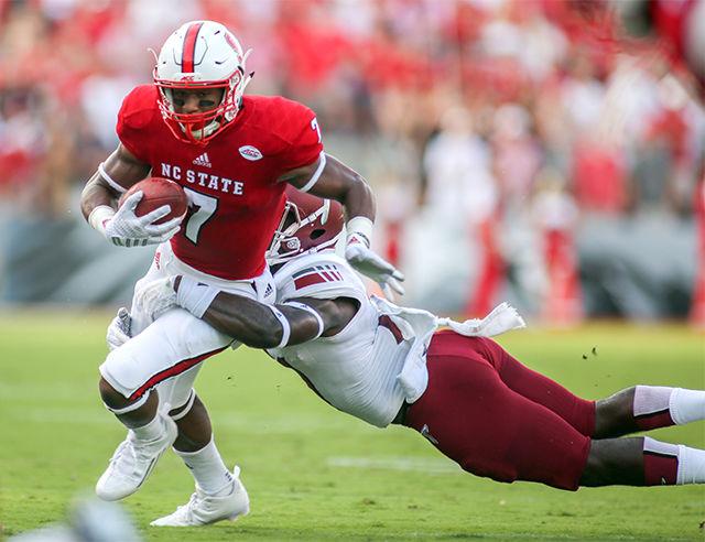 Freshman wide receiver Nyheim Hines makes a run after the catch during the football game against the Troy Trojans. Hines made his debut in front of 57,000 attendees in Carter-Finley Stadium with his first catch for a 5-yard gain. The Wolfpack beat Troy 49-21 during the home opener on Sept. 5.
