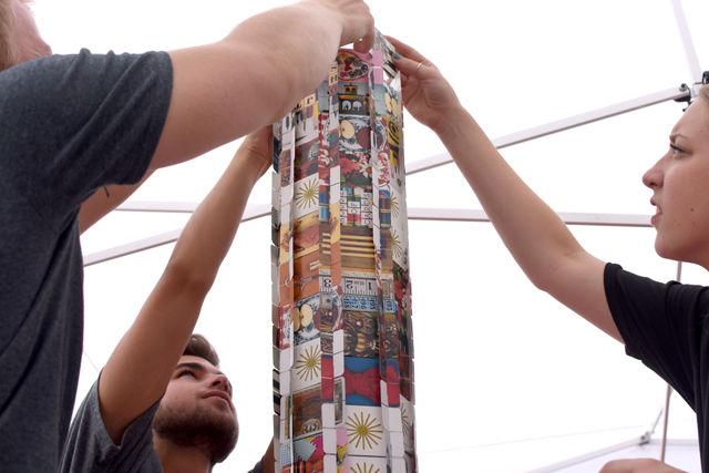 Sam Lackey, a junior studying architecture helps Zachary Hurst, a junior studying accounting, build a card tower. Lackey served as an ambassador for the College of Design at Packapalooza on Aug. 20=.