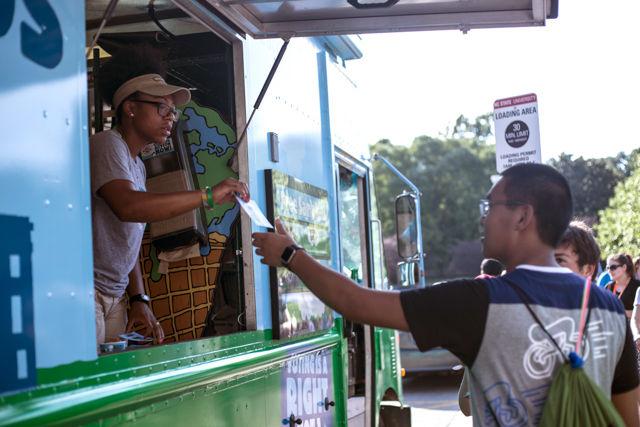 Aquilla Mateen of Ben and Jerry's distributes a voting pledge with cups of ice cream. These refreshments were provided at NC State's Concert on the Lawn, which was hosted by WKNC in front of Witherspoon Student Center on Aug. 15.