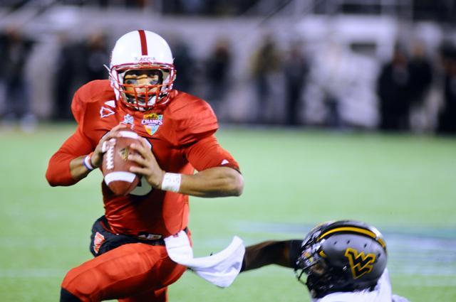 Redshirt junior quarterback Russell Wilson evades a tackler in the second half of the Champs Sports Bowl. Photo by Brent Kitchen.