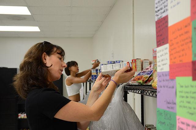Anna Martin checks the expiration dates on items in the Feed the Pack food pantry. Martin is a summer volunteer working her fifth shift so far. The pantry is supported by the Raleigh area and provides support to those in need in the Wolfpack community.
&#160;