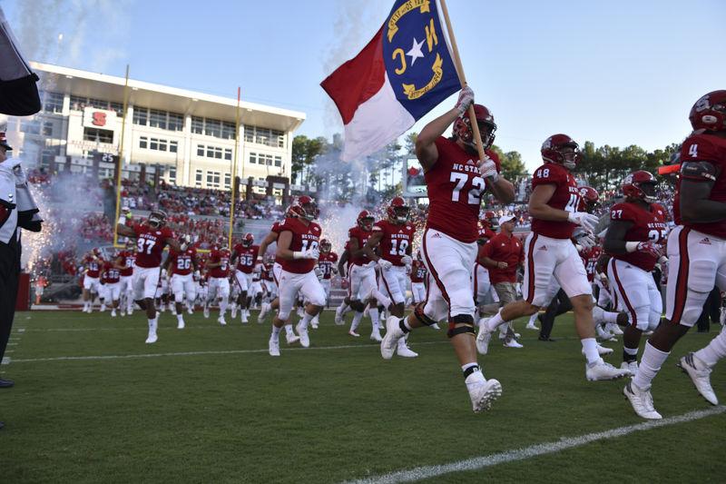 NC State football players storm onto the field at the before kickoff at the game on Saturday, Sept. 17 at Carter-Finley Stadium. The Wolfpack ended the game winning 49 to 22 against Old Dominion.
