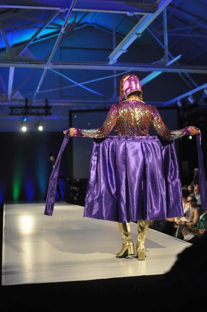 A model wears a piece from Gosha's "Los Luchas" at fashionSPARK's Wear What You Are show held at CAM Raleigh on Sept. 16. The model walked down the runway and dramatically turned around unveiling more underneath all in homage to Lucha Libre Mexican wrestling.