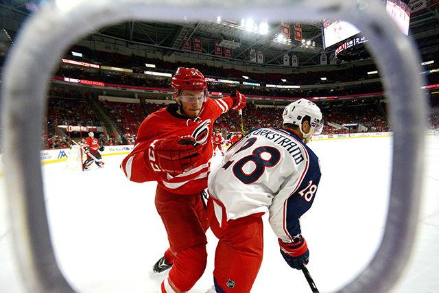 Hurricanes defenseman Brett Pesce attacks Blue Jackets forward Oliver Bjorkstrand during the second period on April 2 at PNC Arena. Bjorkstrand ended up scoring the Blue Jackets' fifth and final goal during the third period. The Hurricanes ultimately fell to the Blue Jackets 5-1.&#160;