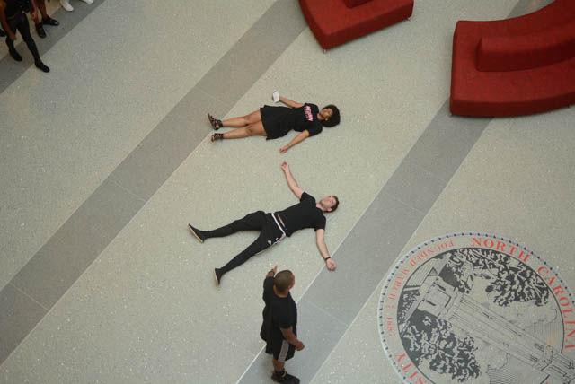 Achaia Dent, a sophomore studying in animal science, and CN Pittman, a senior studying in science, technology and society, lay down on the floor of the atrium in Talley Student Union as a die-in began as a part of the blackout on Sept. 23. For those who were unfamiliar with the form of protest, Student Body Vice President Brayndon Stafford, a senior studying environmental science, explained what it was. Following Dent and CN's example, students filled the floor of Talley Student Union for more than half an hour.