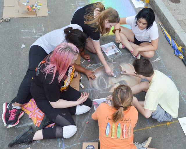 Millbrook High School seniors paint a picture of Frida Kahlo at SPARKcon on Sept. 16. The students were selected by their art teacher to participate in the festival.&#160;