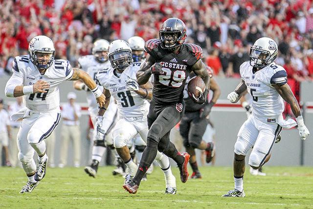 Sophomore Jack Tocho recovers and returns a fumble for a touchdown that ends up being called back during the second quarter against Old Dominion on Sept. 6, 2014. The Wolfpack defeated the Monarchs 46-34.&#160;