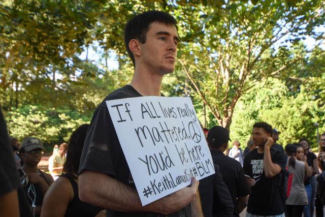 Matthew Judd, a community member, attends the NC Blackout in protest of the recent events in Charlotte and Tulsa. Everyone gathered in Wolf Plaza to listen to speakers as they spoke about the importance of the movement and what every person can do about it.