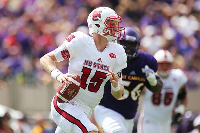 Redshirt sophomore quarterback Ryan Finley rolls out of the collapsing pocket during the game against ECU on Saturday in Dowdy-Ficklen Stadium. Finley was 20-of-31 for 254 yards and a touchdown. Despite putting up nearly 500 yards in the game, the Wolfpack fell to ECU 33-30.
