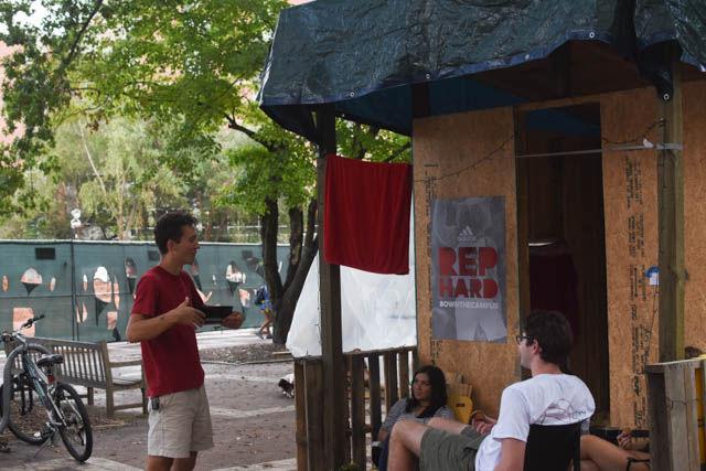 Parker Colbath, a junior studying chemical engineering, talks to Sydney Villarreal, a senior majoring in design studies, while Walker Toohey, a junior studying mechanical engineering, gives away muffins at Shack-a-Thon on the Brickyard on Friday.