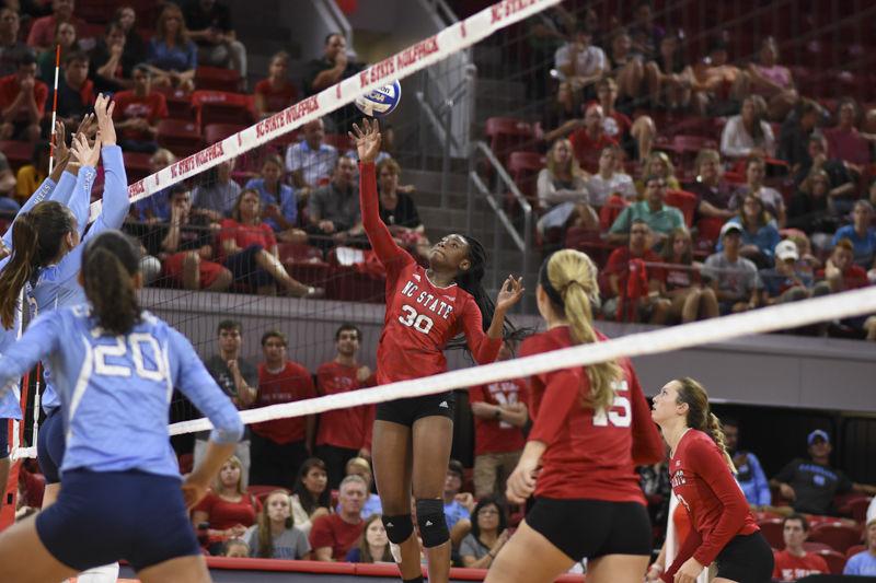 Sophomore middle blocker Teni Sopitan leaps to tip the ball over the net during the Wolfpack's 3-2 loss to UNC-Chapel Hill on Sept. 22, 2016. Sopitan recorded 6 kills and 1 block in the loss at Reynolds Coliseum.