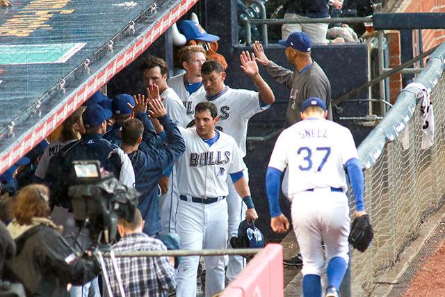The team welcomes players back to the bench who had just crossed home plate during an explosive second inning in the pouring rain. The Durham Bulls took down Charlotte 7-3 on April 7 in the Durham Bulls Athletic Park.