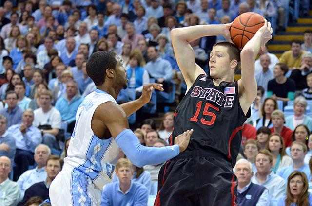 Then-senior forward Scott Wood prepares to pass as he falls back during the basketball game against UNC-Chapel Hill in the Dean Smith Center in Chapel Hill on Feb. 24, 2013. The Wolfpack fell to the Tar Heels 76-65. Wood put 19 points on the board over the course of the game, including five three point field goals.&#160;