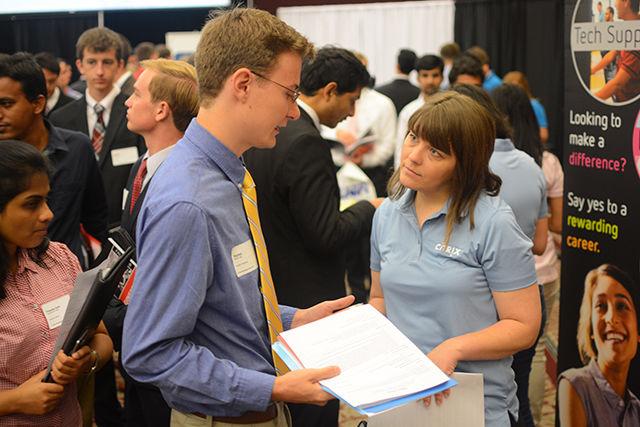 Alex Lilley, a junior studying computer engineering, discusses some projects Citrix is working on with a company representative during the NC State Engineering Career Fair. The NC State College of Engineering hosted its first career fair in 1998, and the event has since grown substantially.&#160;