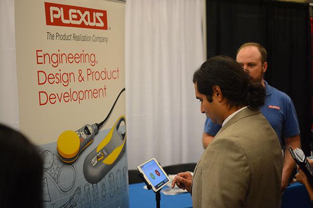 Daniel Vargas, a graduate student studying biomedical engineering at East Carolina University, completes a survey on an iPad brought by Plexus company representatives to the NC State College of Engineering Career Fair on Tuesday in the McKimmon Center. The Engineering Career Fair attracted more than 300 companies from a variety of industries this year. NC State students, as well as those from other universities across North Carolina, attended the fair in hopes of gaining internships, co-ops and employment.&#160;