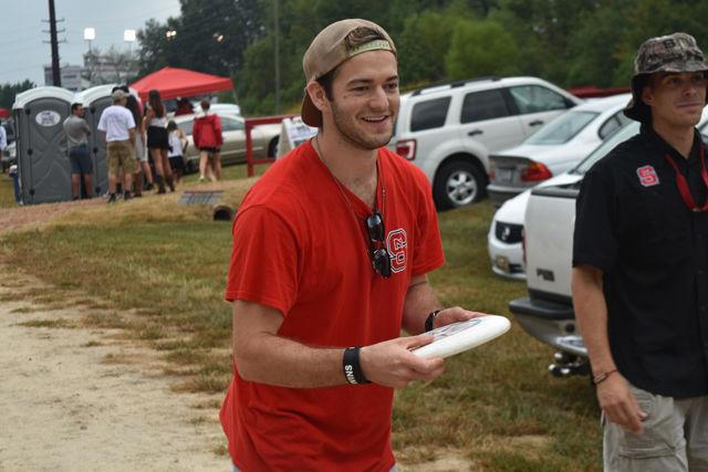 Civil engineering alumnus, Chris Kabrich, throws a frisbee at the first tailgate of the season at Carter-Finley Stadium on Sept. 1. Kabrich said his favorite part of tailgating is playing Kan Jam and eating hushpuppies.