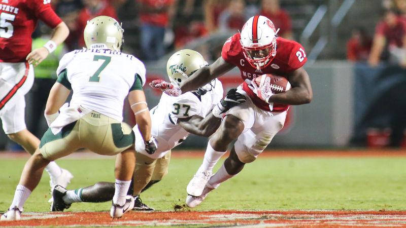 Senior running back Matt Dayes attempts to dodge the Tribe defense during the 48-14 win over William &amp; Mary on Sept. 1 in Carter-Finley Stadium.