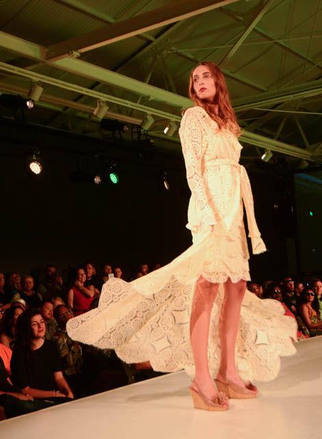 A model showcases one of the pieces from the "Forest Tomlin + Eric Barnes" collection, which consists of laid back women's ware looks with unique itajime shibori dyeing on denim pieces with ornate crochet lace. Forest Tomlin is a senior in fashion and textile management and Eric Barnes is a 2015 alumnus. This collection was one of the eight featured at the Wear What You Are fashion show held on Sept. 16 at CAM Raleigh as part of SPARKcon.