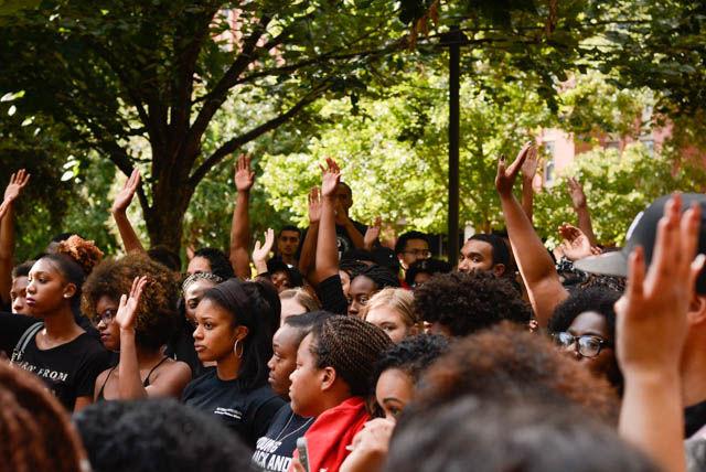 Students raise their hands during the Blackout on Sept. 23 to signify that they are from Charlotte. The Blackout was a response organized by students and Student Government in light of recent police shootings that have happened in both Tulsa in Charlote. The event began in Wolf Plaza at 4 p.m. on Friday, and ended with a die-in on the floor of the atrium in Talley Student Union.