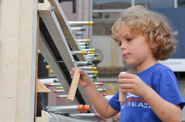 Ryder Kingsley, 4, puts wooden blocks on the gravity xylophone at SPARKcon on Sept. 18. People place a metal ball at the top of the xylophone and gravity moves the ball over metal poles varying in length to produce noise. The wooden blocks stop the metal ball from moving to the next level.