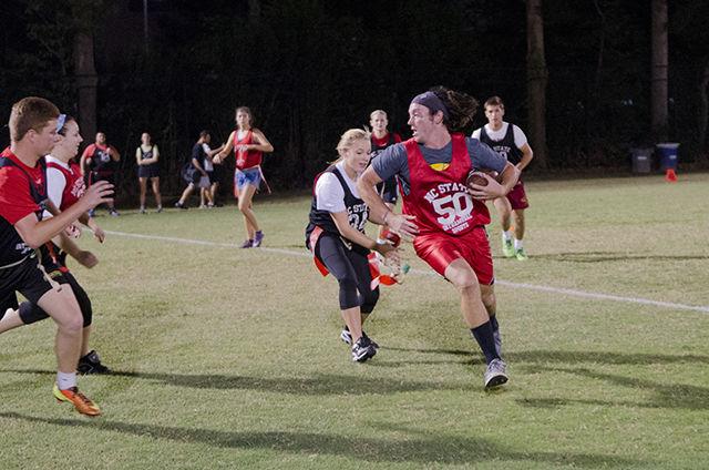 Sarah Woodard, a sophomore studying nutrition science, snatches the flags off of Jonathan Keel, a senior studying mathematics, during an intramural competitive co-ed flag football game on Wednesday at Miller Fields. Intramural flag football had its official season kickoff last week. Co-ed flag football alternates in requiring both sexes to be involved in a successful play for the ball to progress up the field.