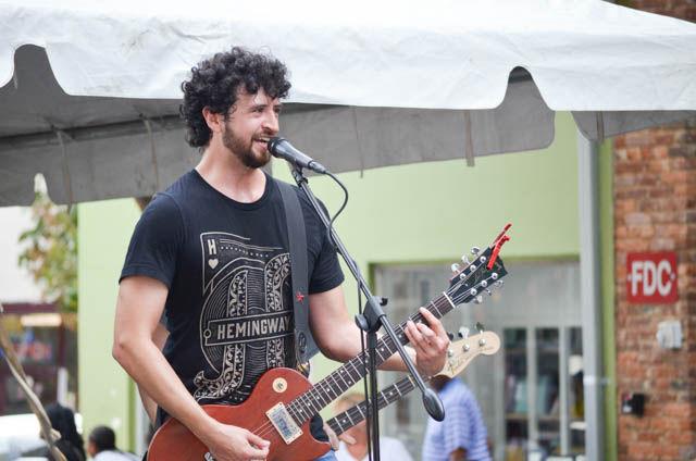 Daniel Stidham, vocals and guitar for Raid the Quarry, strums the chorus of their song Priority One at SPARKcon on the E. Hargett street stage on Sept. 16. Raid the Quarry is a local band from Raleigh, NC. Two of Raid the Quarry's band members are current NC State students.