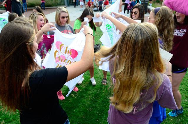A group of rush participants unwrap their shirts revealing which Greek organization accepted them during Bid Day at Stafford Commons on Sept. 14.