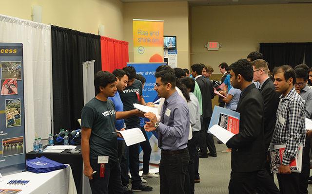 Students form lines to speak with company representatives from VMWare and Dell during the NC State Engineering Career Fair at NC State's McKimmon Center on Tuesday, Sept. 20, 2016. This is the 18th year that the College of Engineering has hosted its career fair, and the event has gradually grown into a two-day event that attracts over 300 companies.. Students attended the fair in hopes of getting real-world exposure to industry through internships and co-ops, as well as jobs in the various industries the companies represented.