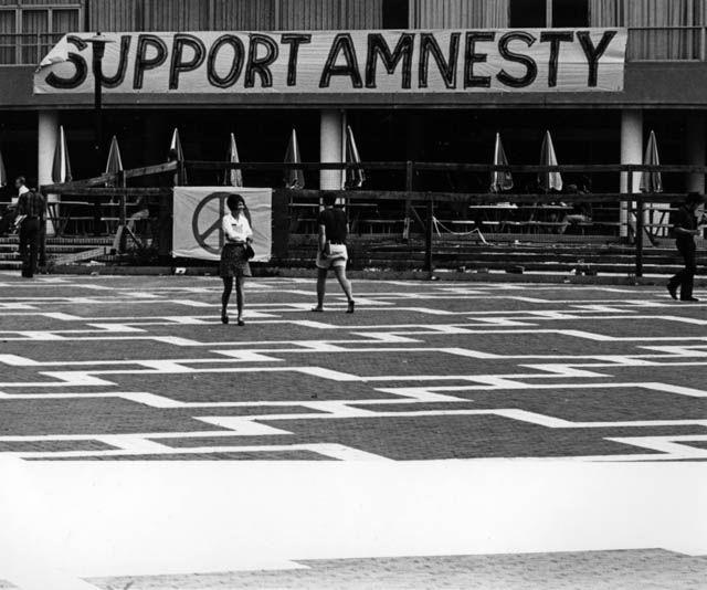 Circa 1968: A banner reading &#8220;Support Amnesty&#8221; adorns former building Harrelson Hall.