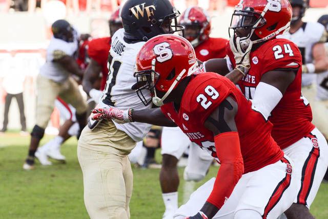 Graduate cornerback Jack Tocho dodges around a Wake Forest player. Tocho had an interception in Wolfpack's 33-16 win against Wake Forest University at Carter-Finley Stadium on Oct. 1.