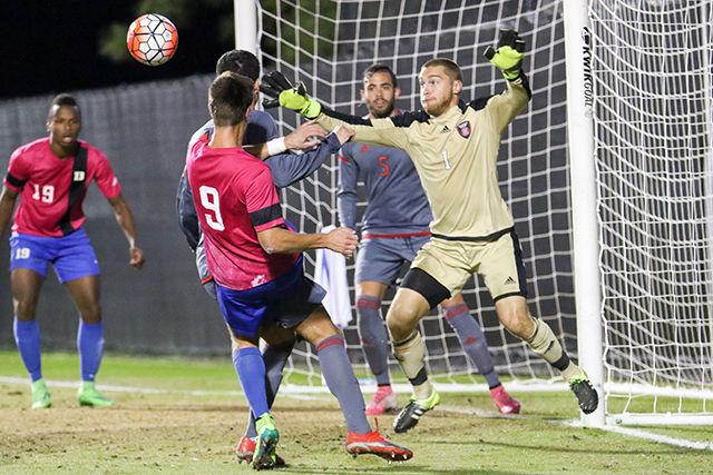 Then-redshirt junior goalkeeper Alex McCauley saves a goal by deflecting the shot by a Duke forward. The Wolfpack played a man down for 66 minutes of the game due to a red card in the first half, which was proven to be detrimental. The Wolfpack lost to Duke 6-2 in Koskinen Stadium at Duke on Oct. 17, 2015.&#160;