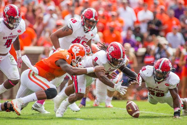Senior nickelback Dravious Wright and Junior linebacker Airius Moore dive for, and recover, a Clemson fumble deep in Clemson territory. Both Wright and Moore recovered for no yards and the defense had a stellar day with Clemson seeing five fumbles and throwing one interception. The Wolfpack fell in overtime to No. 3 Clemson 24-17 on Oct. 15 at Death Valley in Clemson, SC.
