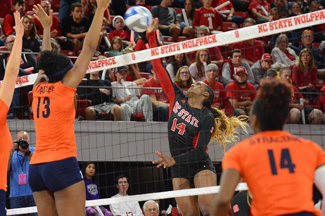 Junior outside hitter Erin Chatman jumps to spike the ball, attempting to push it past the Syracuse defense on Friday in Reynolds Coliseum. Chatman achieved five spikes and six kills. The Wolfpack won the game with the score 3-2.