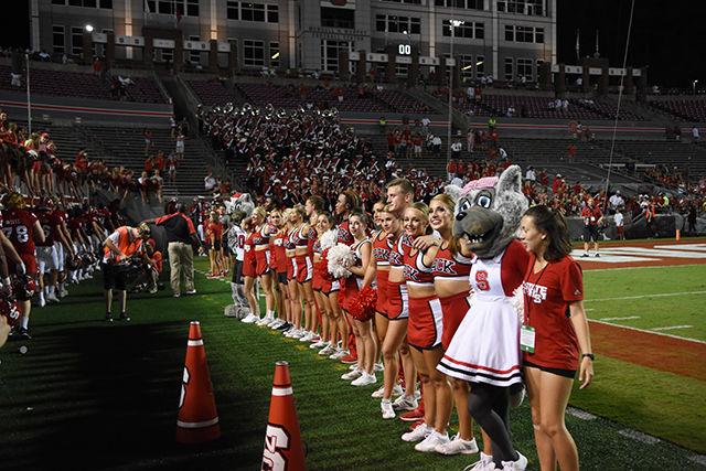 Cheerleaders line up with Mr. and Mrs. Wuf at the end of the football game against Old Dominion on Sept. 17 in Carter-Finley Stadium. The Wolfpack ended up with a win against Old Dominion of 49-22.