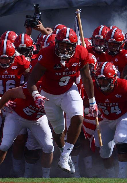 The NC State football team rushes out to the field with a big bang from the fireworks and smoke. The Wolfpack won the game against Wake Forest with a score 33-16 in the Carter-Finley Stadium on Oct. 1, 2016.