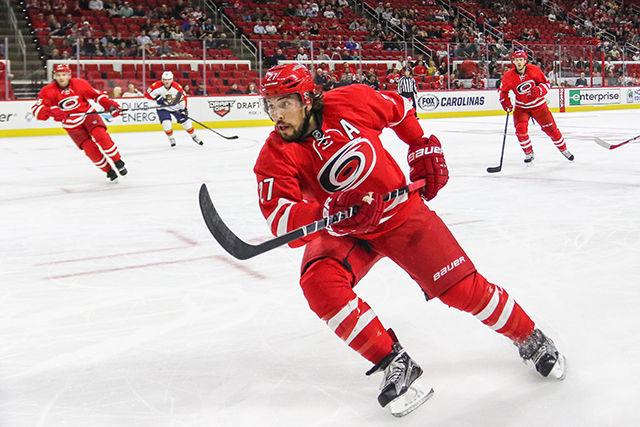 Defenseman Justin Faulk carries the puck through the neutral zone looking for an open pass. Faulk, who served as an alternate captain last season, is a strong candidate for the captaincy, left open after the trade of former captain Eric Staal.&#160;