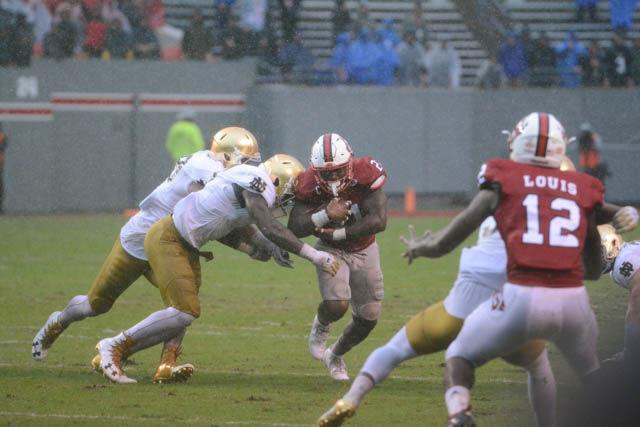 Senior running back Matt Dayes earns part of his 123 net rushing yards against the Fighting Irish on Oct. 8 at Carter-Finley Stadium. The Wolfpack overcame the weather and won 10-3.