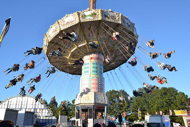 A rotating giant swing allows dozens of fairgoers to fly around at the NC State Fair on Saturday, Oct 17, 2015.