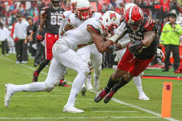 Then sophomore running back Jaylen Samuels catches a pass from quarterback Jacoby Brissett for a touchdown against the Cardinals. Samuels finished the game with five catches for 75 yards and a touchdown. NC State was defeated 13-20 against the Louisville Cardinals in Carter-Finley Stadium on Oct. 3, 2015.