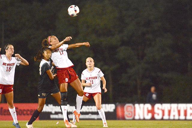 Senior forward Gladys Loyas battles a Wake Forest player for the ball in Dail Soccer Stadium. The NC State Wolfpack won against the Demon Deacons 2-1 on Sunday.