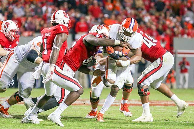 The Wolfpack defenders fail to make a tackle against the Clemson offense when attempting to run past the line of scrimmage. The NC State defense let up 623 yards, 27 first downs, five throwing touchdowns and two rushing touchdowns against the Clemson Tigers. The Wolfpack fell to the Tigers 56-41 in Carter-Finley Stadium on Oct. 31, 2015.