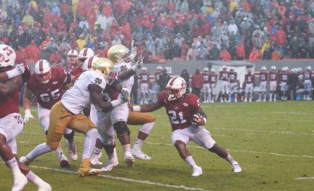 Senior running back Matt Dayes stiff arms a Notre Dame defender on Oct. 8 in Carter-Finley Stadium. Dayes led the Wolfpack to a 10-3 victory with 23 rushing attempts for a net gain of 126 yards.