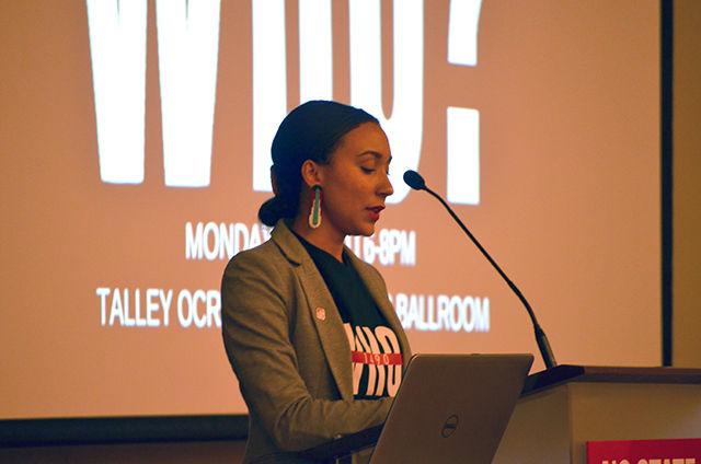 Brittany Hunt, assistant director of Native American Student Affairs, introduces the guest speaker, Nara Dial Stanley, on Monday at the Indigenous Peoples' Day event. Brittany explains the importance of maintaining diversity in today's society and empowers the public to maintain their cultural practices. The event was titled "1490 Who?" to question the whose day it actually is.