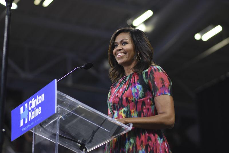 First lady of the United States Michelle Obama smiles as students, supporters and attendees cheer during her speech at Reynolds Coliseum on Oct. 4, 2016. Obama spoke about her endorsement of Presidential Candidate Hillary Clinton and urged everyone to get out and vote in this election.