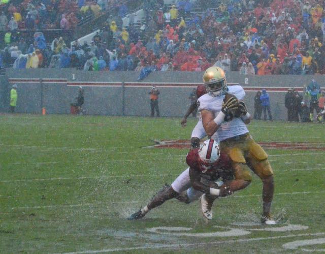 Wolfpack junior cornerback Mike Stevens tackles the Notre Dame ballcarrier in the game against the Fighting Irish on Oct. 8. NC State won a hard fought game in the rain 10-3 and celebrated the 50th anniversary of the first game played in Carter-Finley Stadium.
