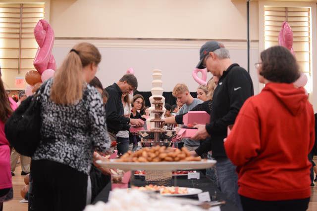 Attendees treat themselves to a variety of sweets found at the Chocolate Festival on Sept. 30 in the State Ballroom of Talley Student Union. The Chocolate Festival is an annual event hosted by the Women's Center to raise money for programming efforts within the Women's Center and for the Kay Yow Cancer Fund. Event attendees paid a ticket price of $10 to get to taste a variety of chocolates from local vendors.