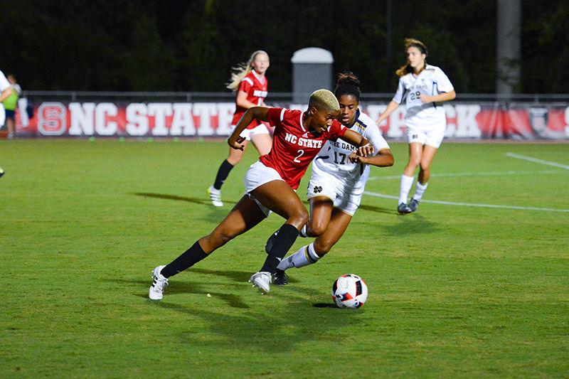 Freshman midfielder Tziarra King sprints will dribbling the ball around a Notre Dame player. King didn't take any shots during the game but played almost the entire game at 86 minutes. The NC State women's soccer team lost to Notre Dame 1-0 at Dail Soccer Stadium.