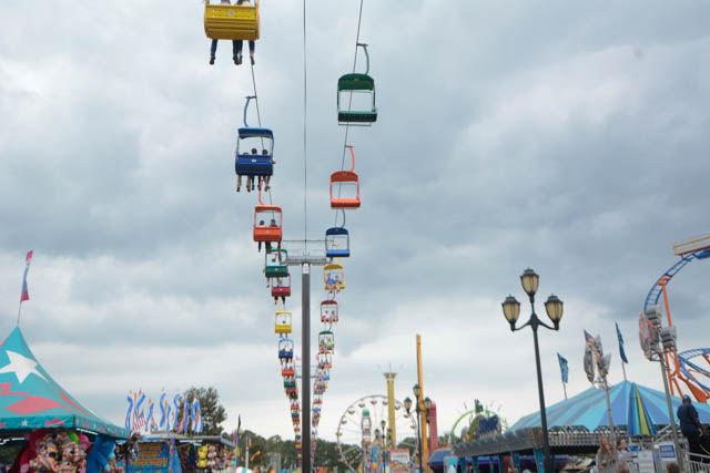 Fairgoers take a ride on The State Fair Flyer, the newest permanent addition to the fair, which allows for them to take a chairlift ride to see the fair from up high. Tickets are $5 for a one-way trip and $8 for a roundtrip. The 149th annual NC State Fair featured a variety of attractions including animals, rides, food and more.