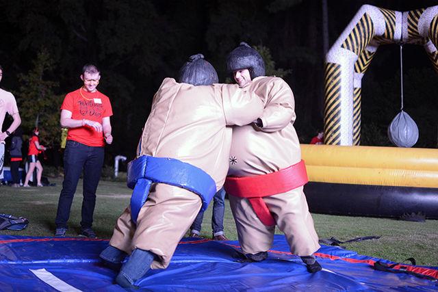 Steven Favorite, a junior studying electrical engineering, maintains his balance as Sandeep Gill, a sophomore studying statistics, tries to push him over at the sumo wrestling station of Wolfpack After Dark. The event took place on Stafford Commons Friday night and was hosted by NC State's Union Activities Board. Giant inflatable Twister and cornhole were among the several different games students could play as part of the event.